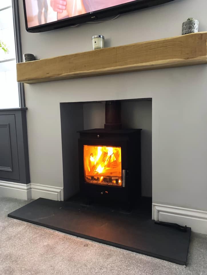 Finished stove installed in a clean fireplace recess