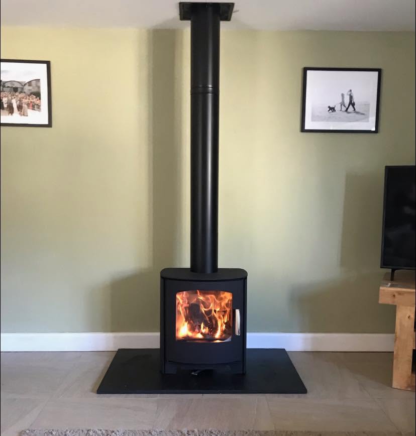 Freestanding stove on a dark hearth