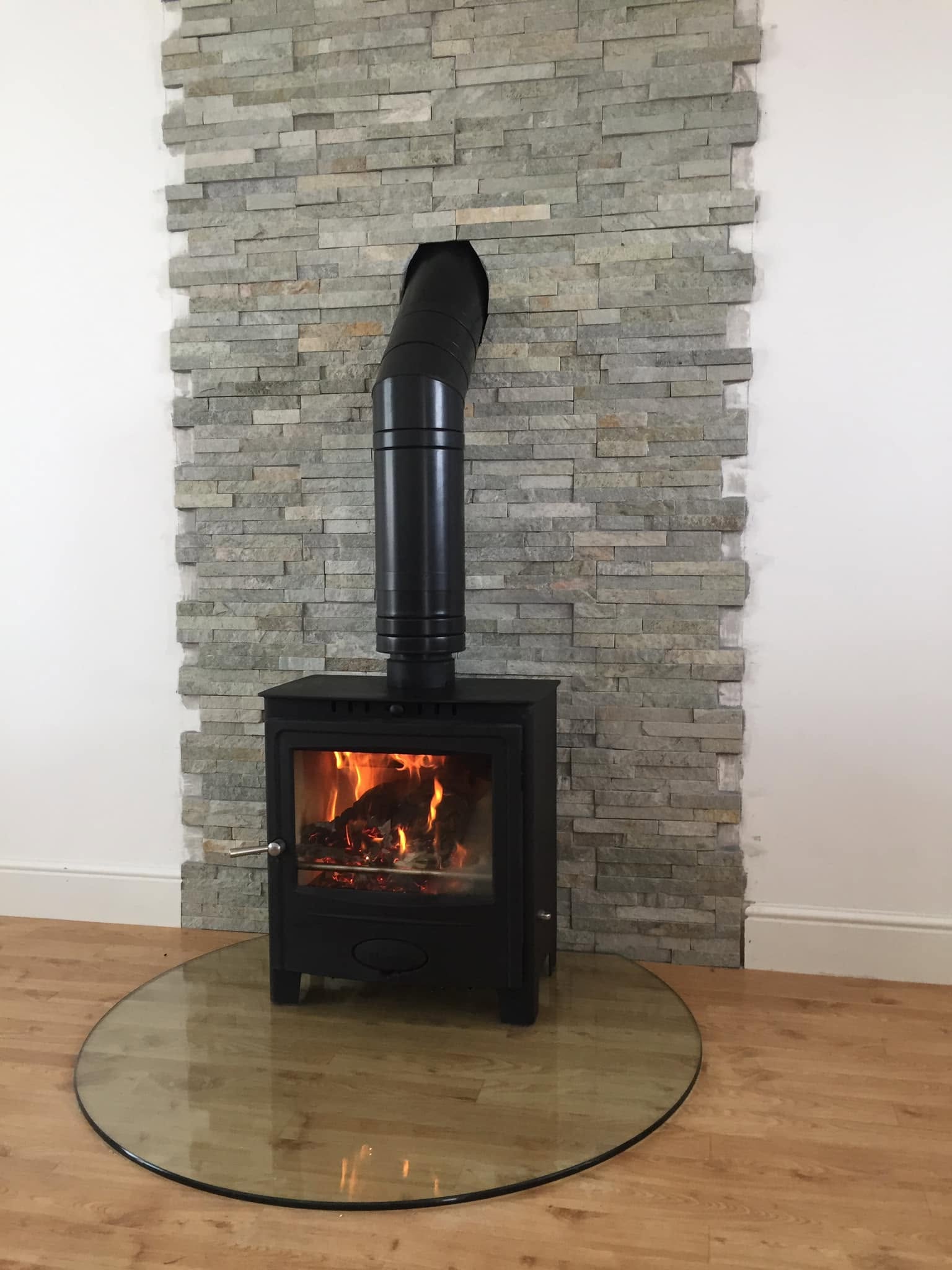 Completed South Wales Stoves installation with stone feature wall