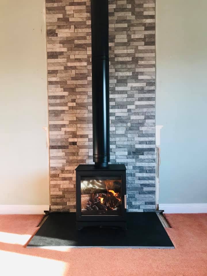 Completed stove installation against a tiled feature wall