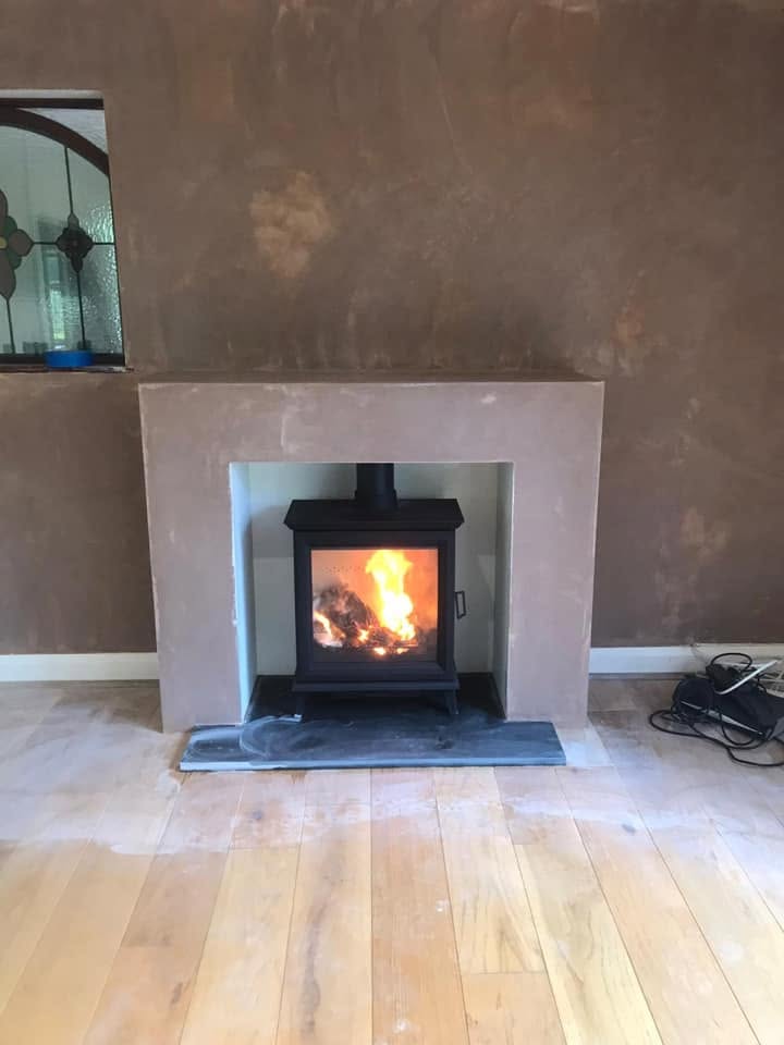 Finished stove installation after full fireplace rebuild